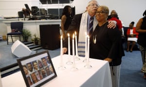 Rabbi Israel Zoberman, left, embraces churchgoer Pamela Johnson after a vigil at Piney Grove Baptist Church.